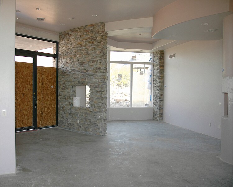 Looking towards the front door (yes we will be replacing the wood with glass) and the dining room.  Using the stone on an inside wall adds an interesting touch to the entry.\n(January 2005)